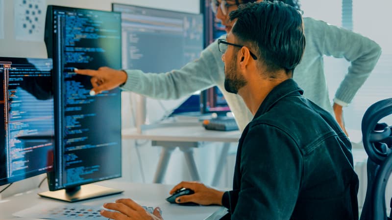 Two Java developers working together at a fintech firm