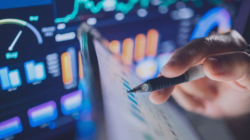 Person Working On A Ipad Showing Stats