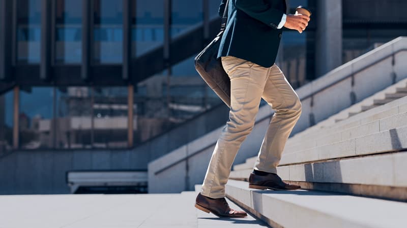 Male Climbing The Steps With A Coffee