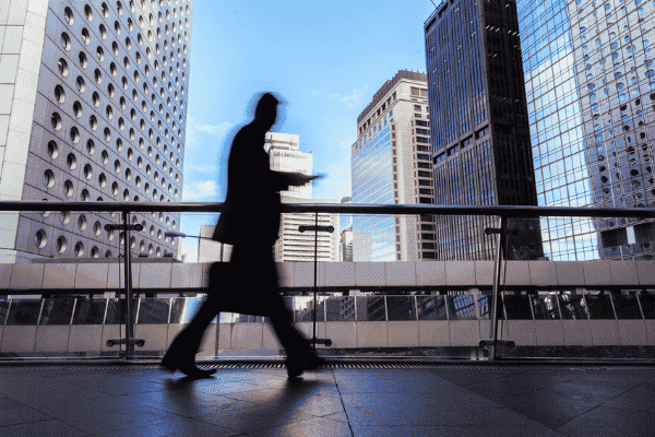 Equities Professional Walking In Hong Kong's Financial District